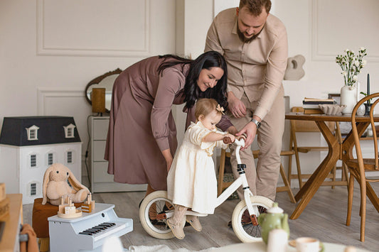 Happy family spending time together in a bright, modern children's bedroom featuring wooden furniture.