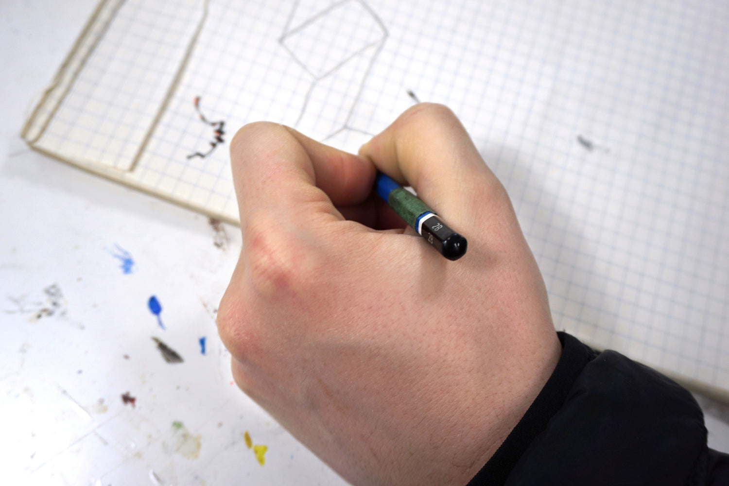 Hand sketching the design plan for the Junio bunk bed — highlighting its minimalist structure, safe layout, and sustainable wood construction for children’s rooms.